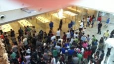 A crowd of people wait to enter the Apple store at the Mall at Millenia. (Red Huber, Orlando Sentinel )