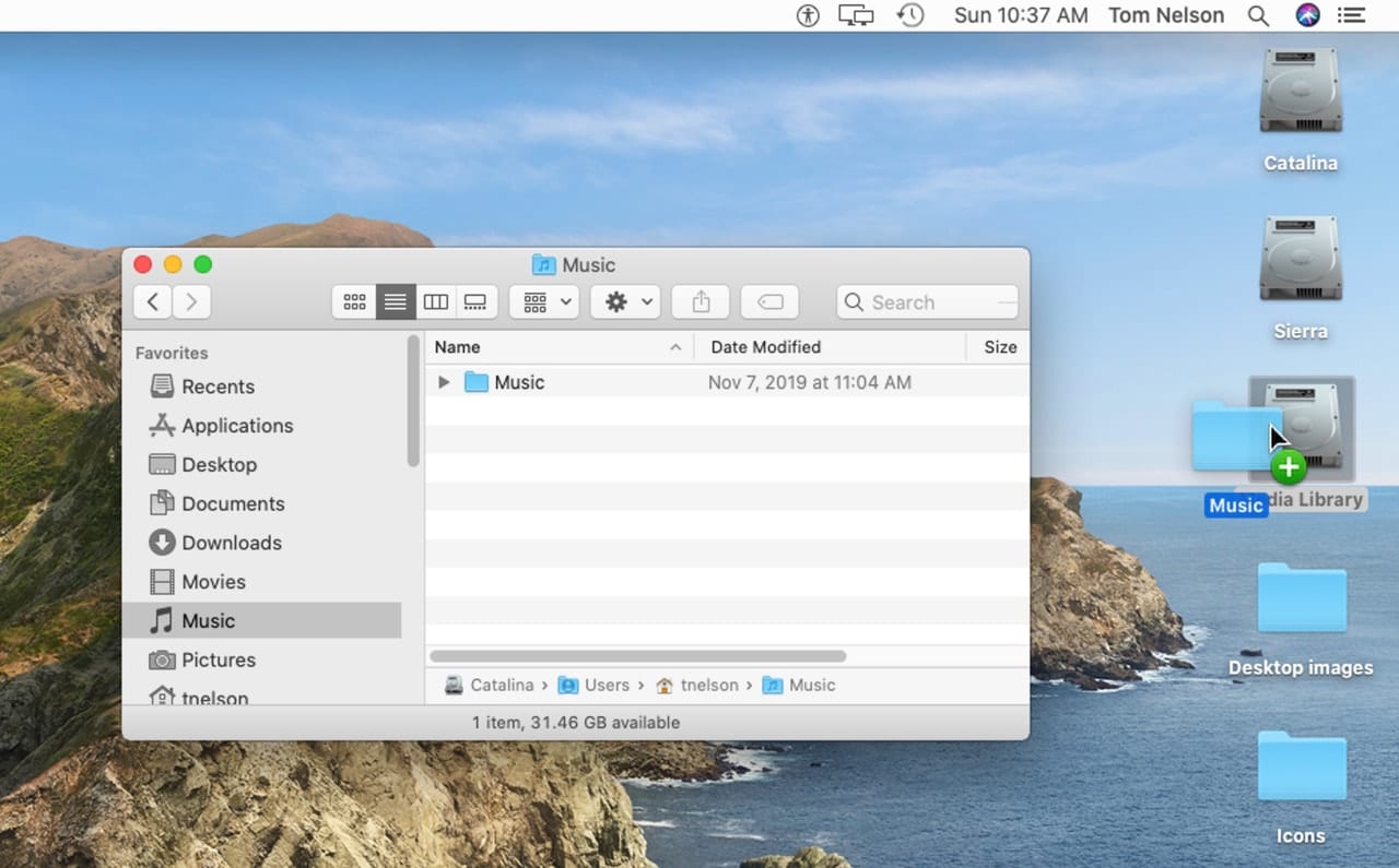 macOS Catalina desktop with Music folder being dragged to an external drive.