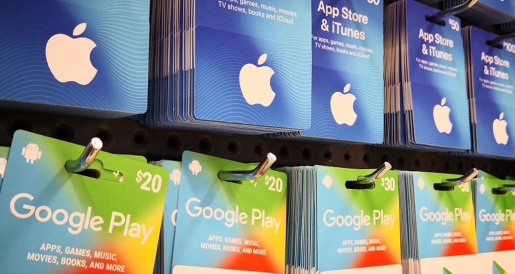 App store and iTunes gift cards and Google Play gift cards on a rack