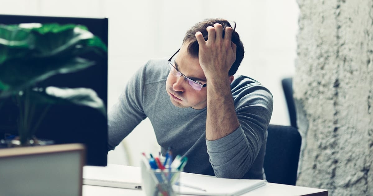 Frustrated man in front of a computer
