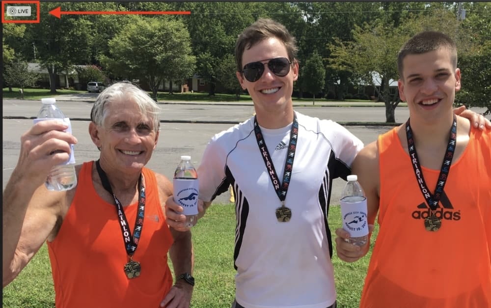 A father and two sons holding water bottles after a run