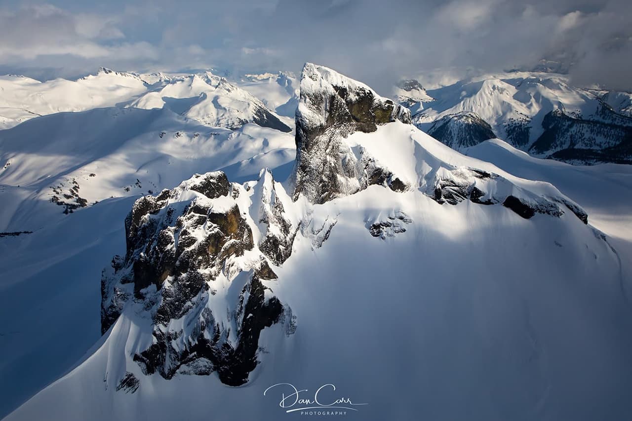 Ariel photo of a snow-capped mountains. Photographed by Dan Carr.