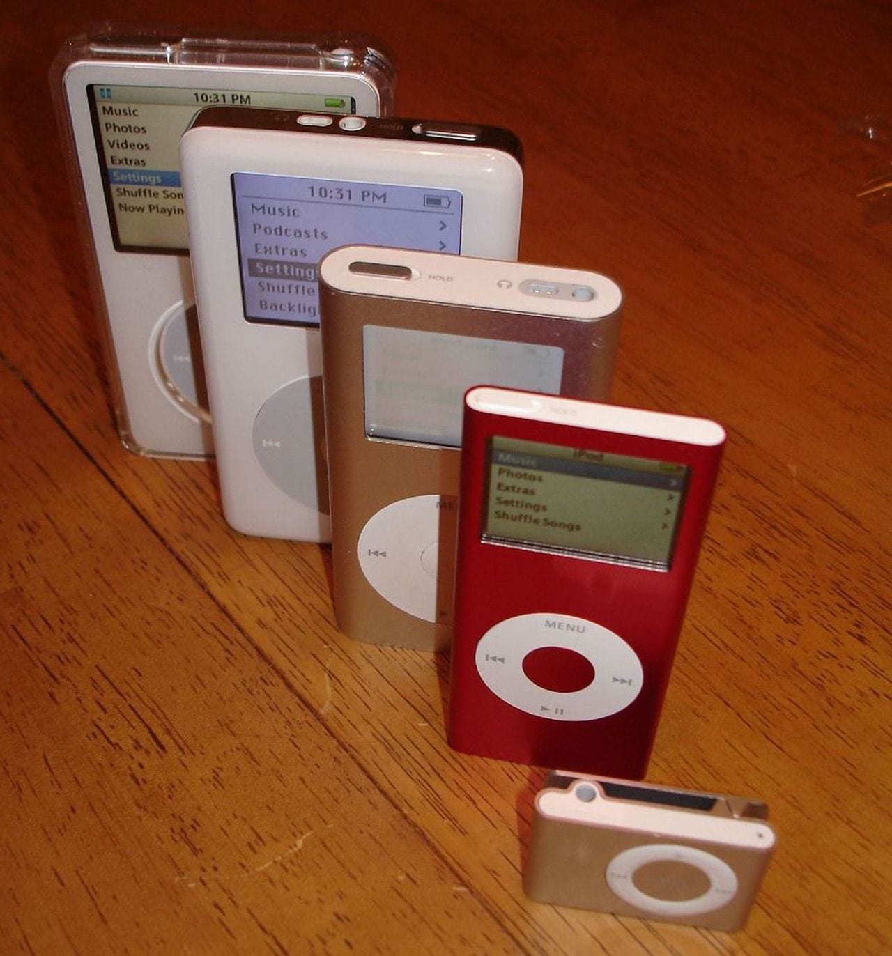 Image showing (left to right) a color display 80GB iPod Video, a 4th-generation 20GB iPod Classic with monochrome display, a 4GB iPad Mini, a Product(RED) 2nd-generation iPad Nano, and a 1GB 2nd-generation iPod Shuffle. Photo CC BY-SA 2.0, Chris Harrison