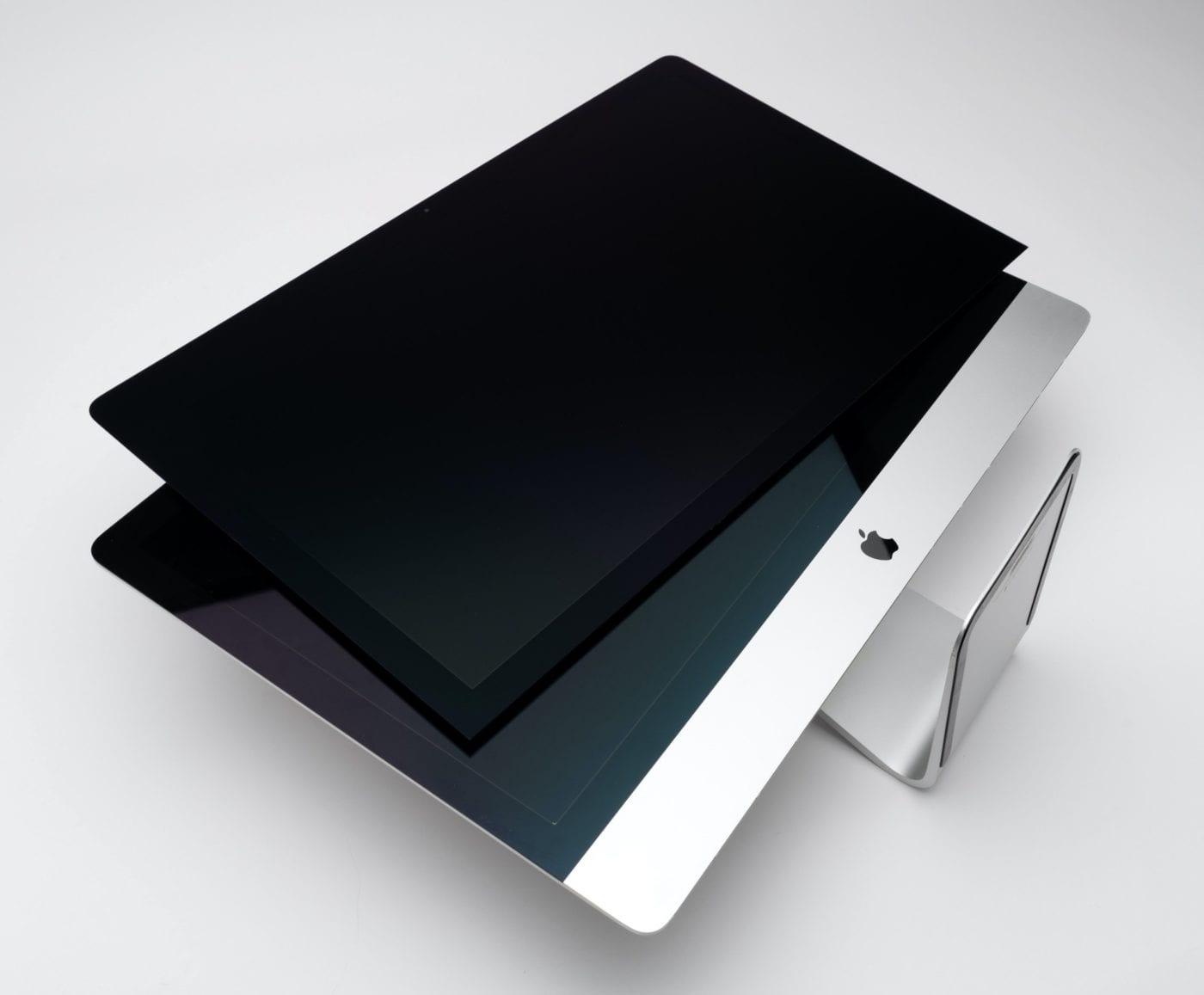 Apple's new nano-textured glass laying on top of the standard 2020 iMax 27" to contrast the difference.