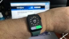 Apple Watch on an arm showing +6 minutes ahead