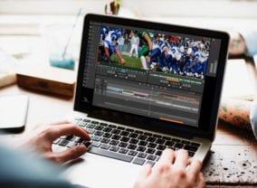 Laptop with someone editing an NFL game via the cloud