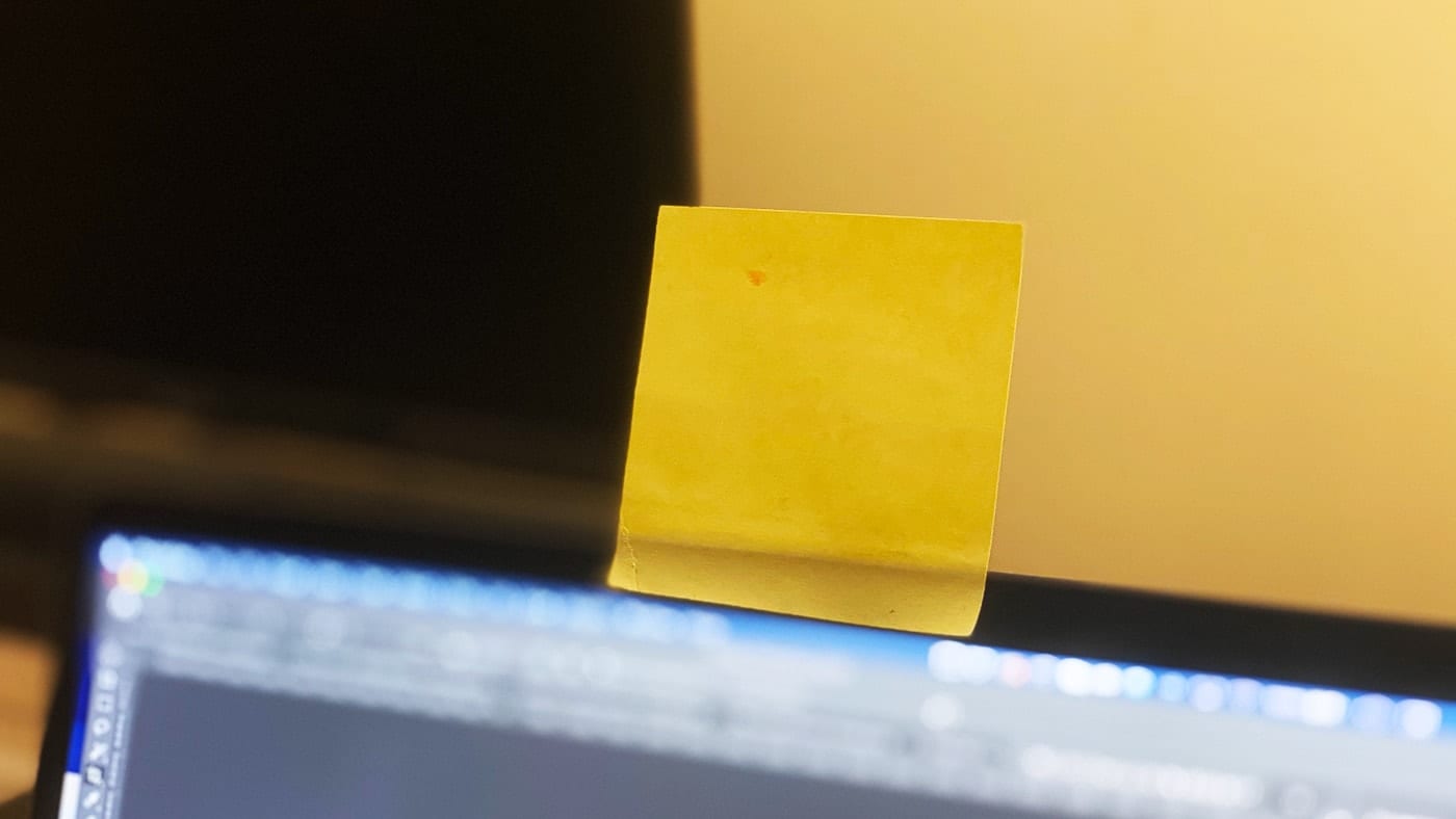 MacBook Pro with a yellow sticky note covering the FaceTime camera