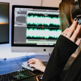 Girl with headphones editing audio and video