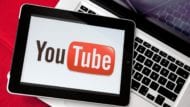 YouTube Logo on an iPad resting on a MacBook Pro