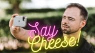 Neon "Say Cheese" with man holding camera