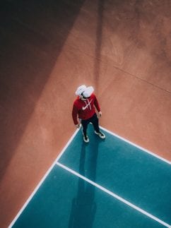 Person wearing VR headset on a tennis court