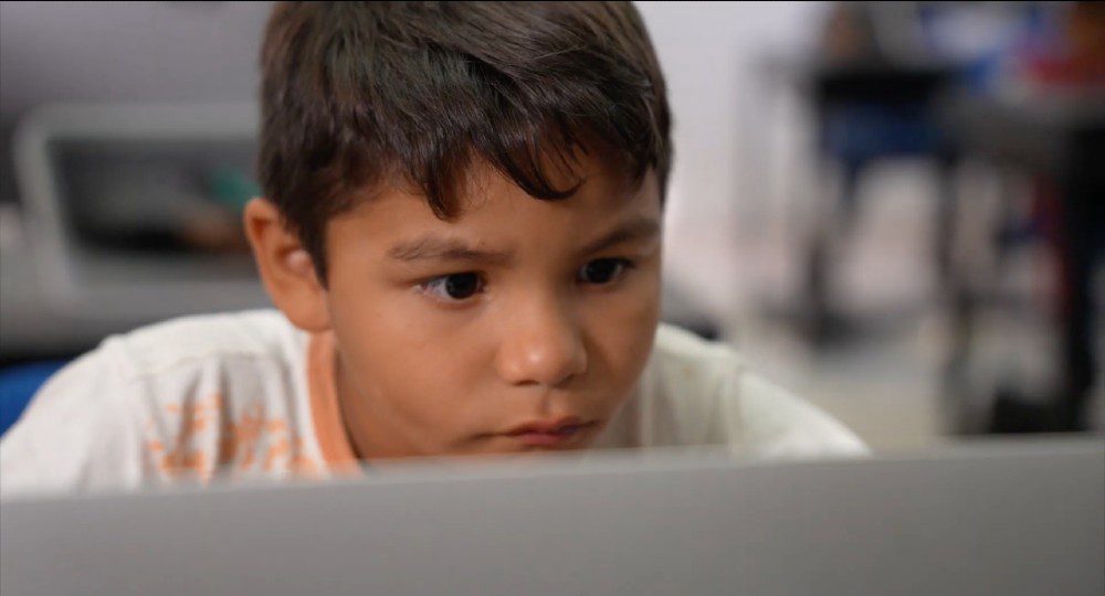 Little boy looking at laptop
