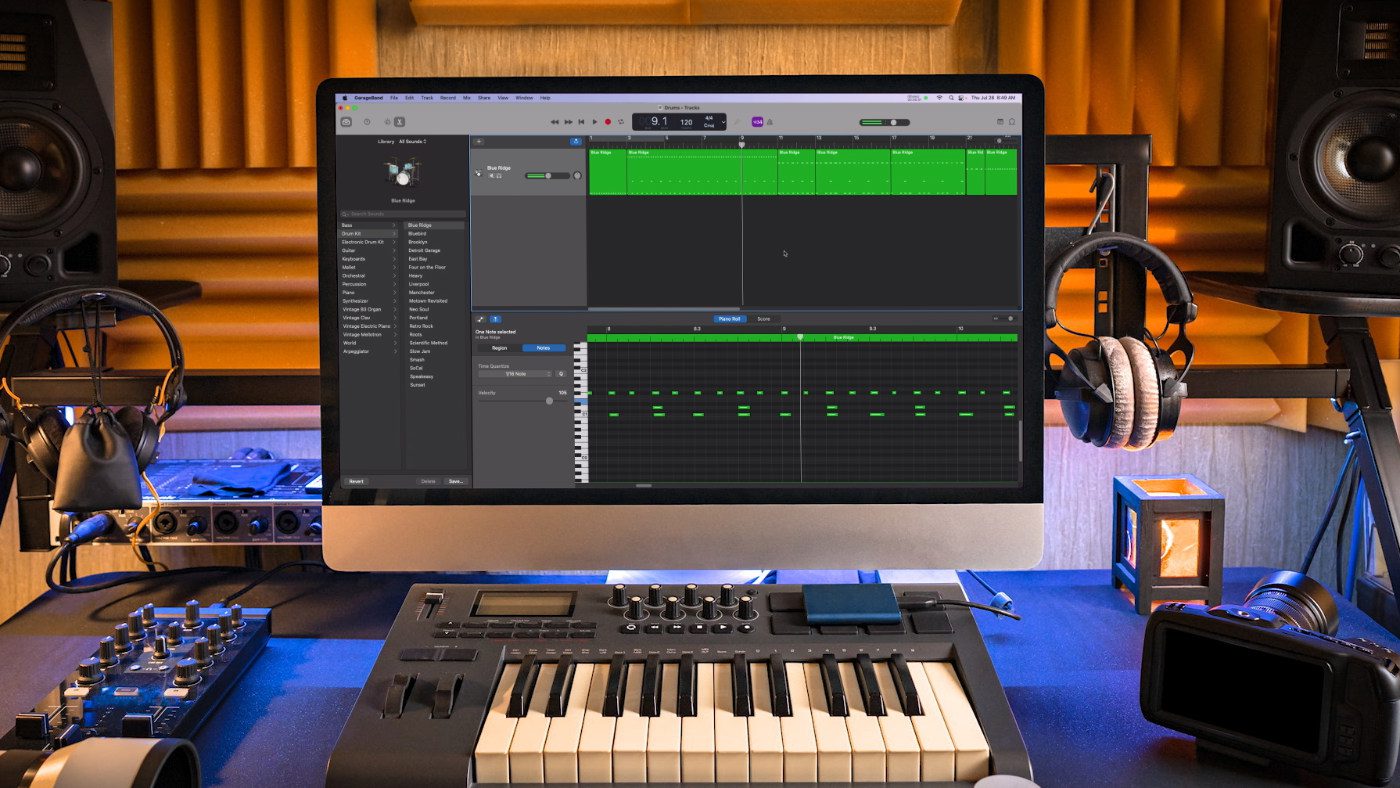 A small MIDI keyboard connected to an iMac with the GarageBand application open.