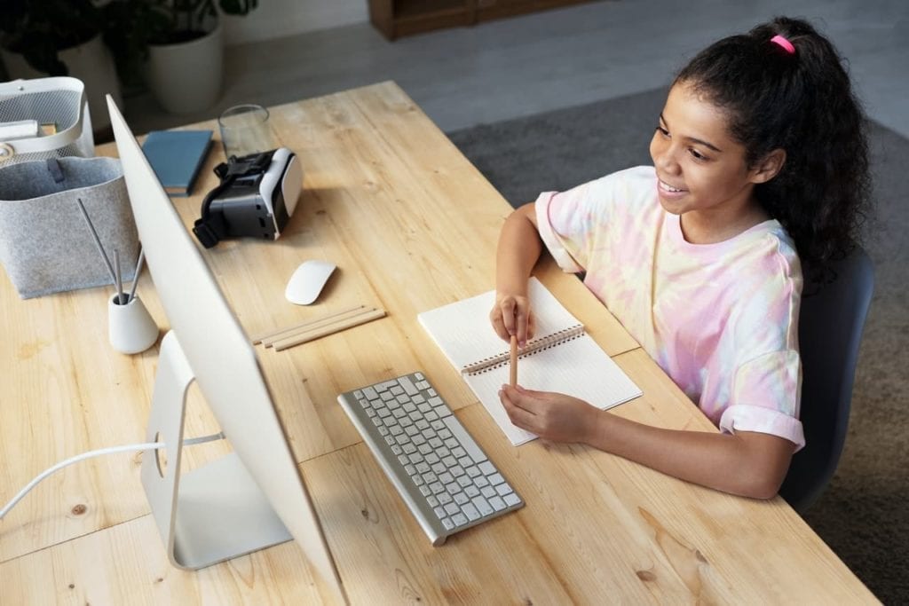 girl in pink shirt with iMac